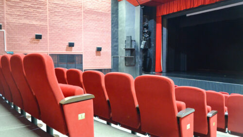A close-up view of the foldable upholstered seats in the cinema and theatre hall 