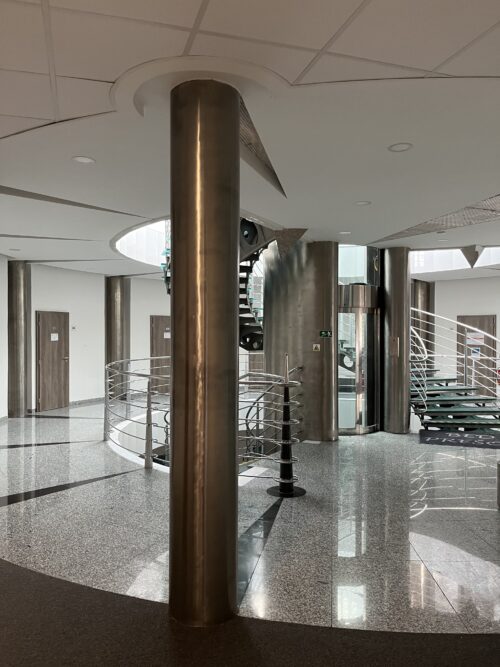 Dominant elements of the hall are columns wrapped in stainless-steel sheets