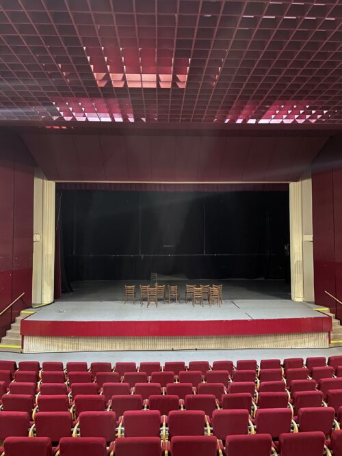 The interior of the Red Room with a typical suspended grid ceiling and stage curtains preserved to date 