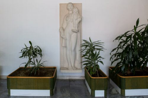 The front wall of the entrance hall is adorned with a relief "Mother and Child" by sculptor Michal Czupil 