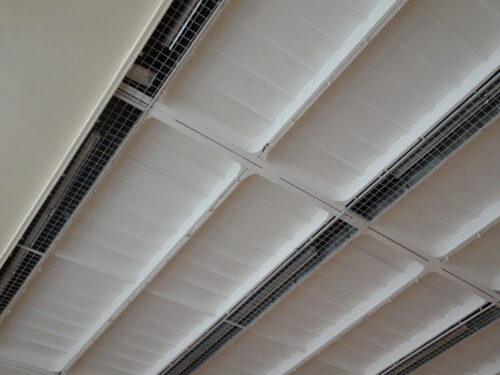 Telocvičňa – detailný pohľad podhľad na betónové stropné panely s nadčasovo integrovanými lineárnymi svietidlami