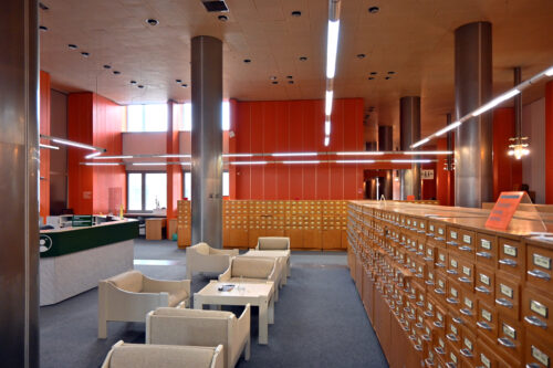 Section of the information desk and filing cabinets on the second floor – the renovation of this area included the change of the graphic signage in the counter section, new lights and reupholstering of the armchairs