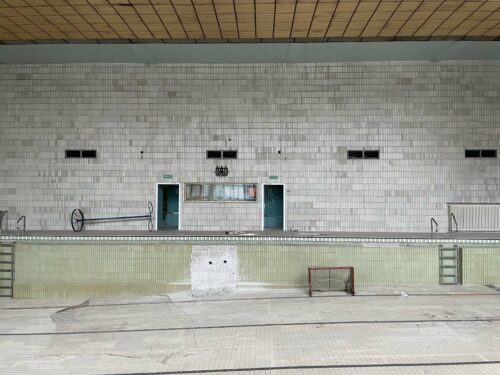 The swimming pool today – wall and floor tiling is made up of small-format ceramic tiles of square and rectangular shapes in grey-green, light green, sand and white colours 