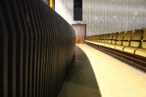 The cinema and theatre hall – detailed view of the wooden panelling of the front stage wall preserved to date