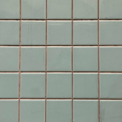 Small-format ceramic tiles used on the walls in the showers and sauna area