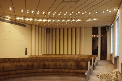 The main expression dominants of the ceremony hall are seats lined up in an arch and the unique light installations 