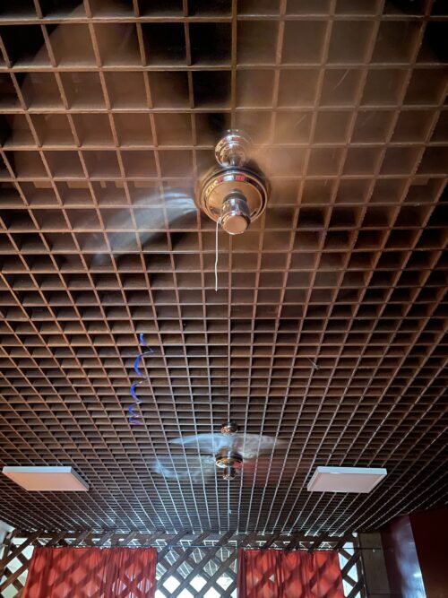 Suspended grid ceiling reflecting the style of expression of then period is now complemented with new lights and ventilators