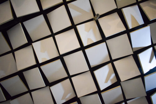 The suspended ceiling creates attractive visual patterns using spatial rotation of the square plates and tubular lights