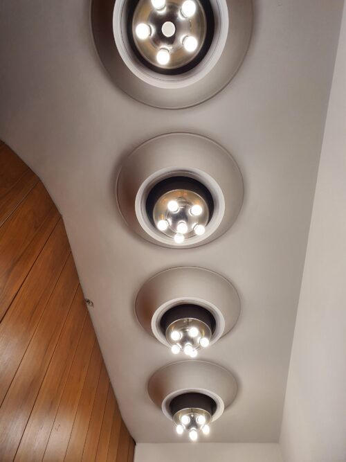 The lights are designed in an artistic and structural symbiosis with the shaped plaster ceiling 