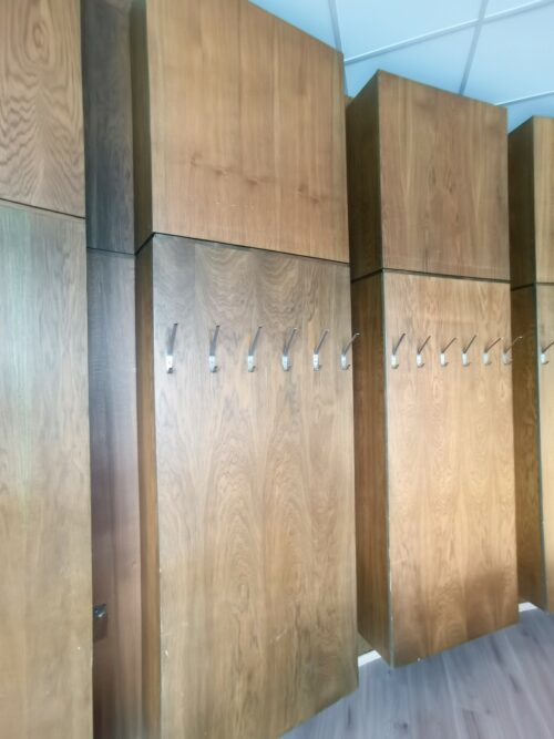 Wooden wall panelling in the meeting room also has a wall hanger function