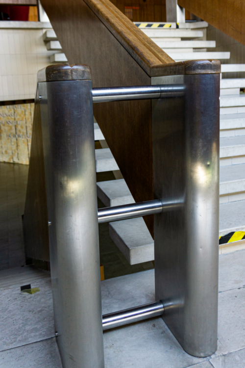 The use of metal in the staircase design is a visual reference to the metal columns in the foyers’ interiors